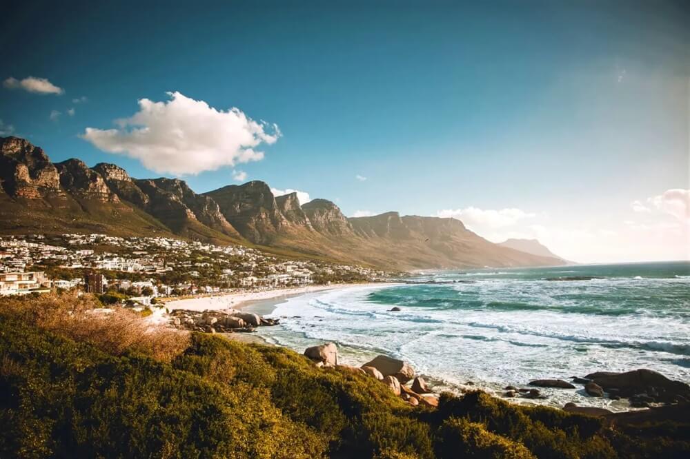 Picture of campsbay beach and mountain range.
